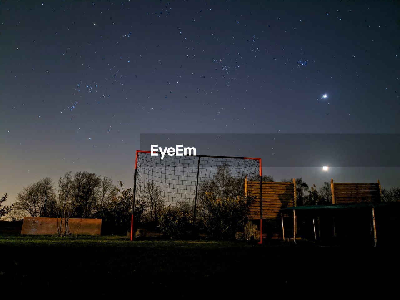 Soccer field against sky at night