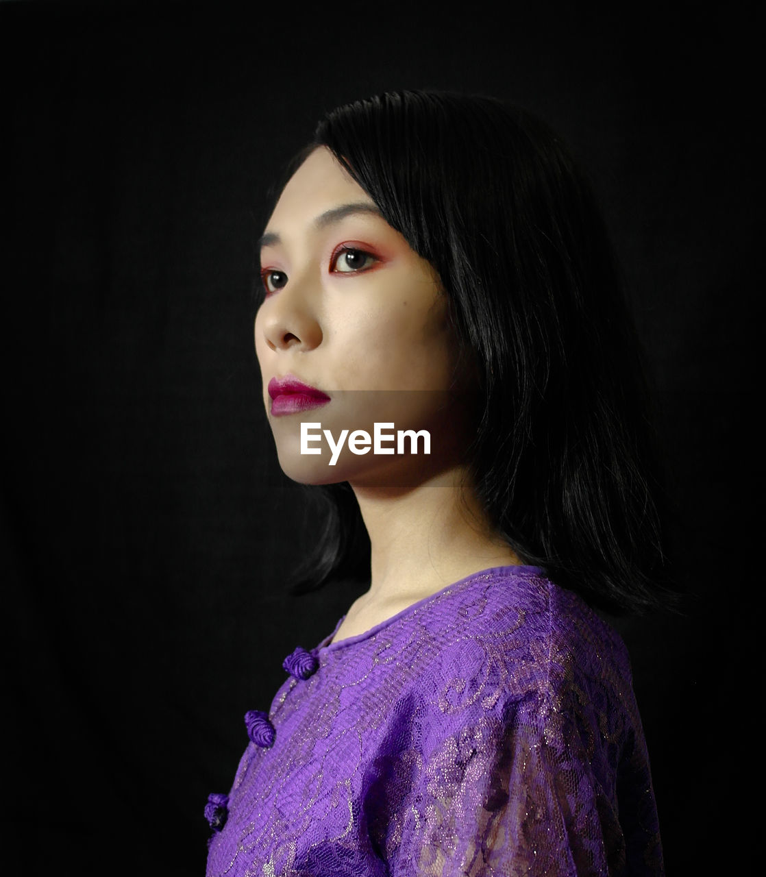 Portrait of a beautiful young woman over black background