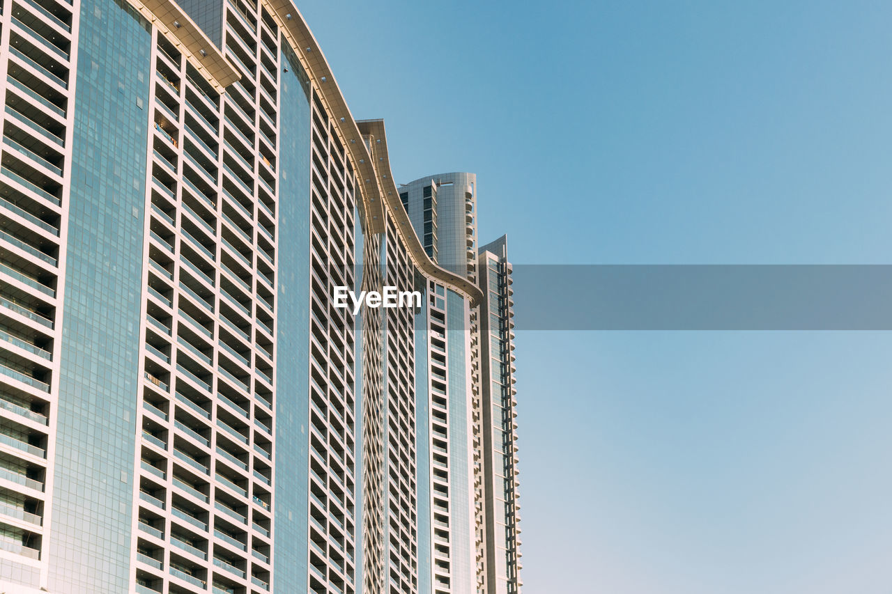 low angle view of skyscraper against blue sky