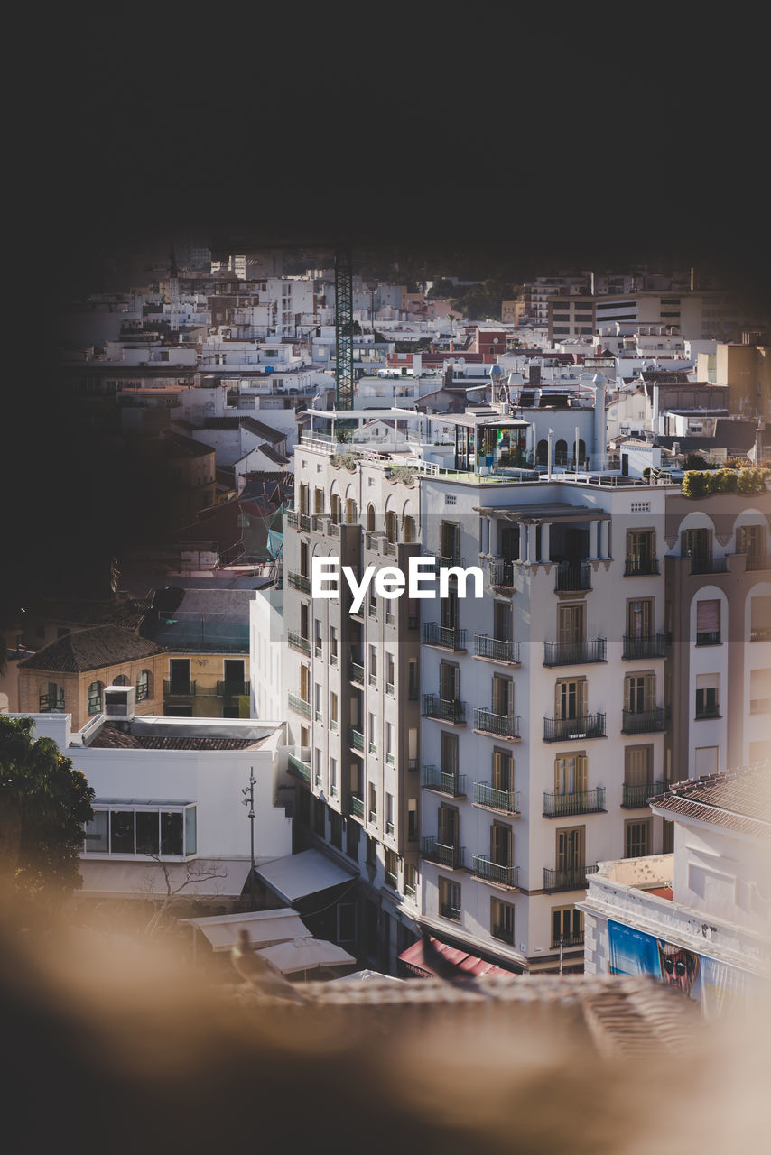 HIGH ANGLE VIEW OF BUILDINGS IN CITY AGAINST SKY