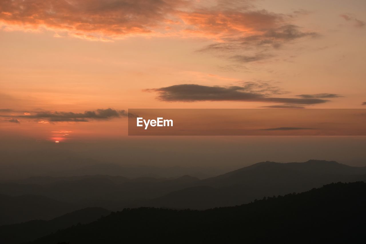 SCENIC VIEW OF SILHOUETTE MOUNTAINS AGAINST ROMANTIC SKY DURING SUNSET