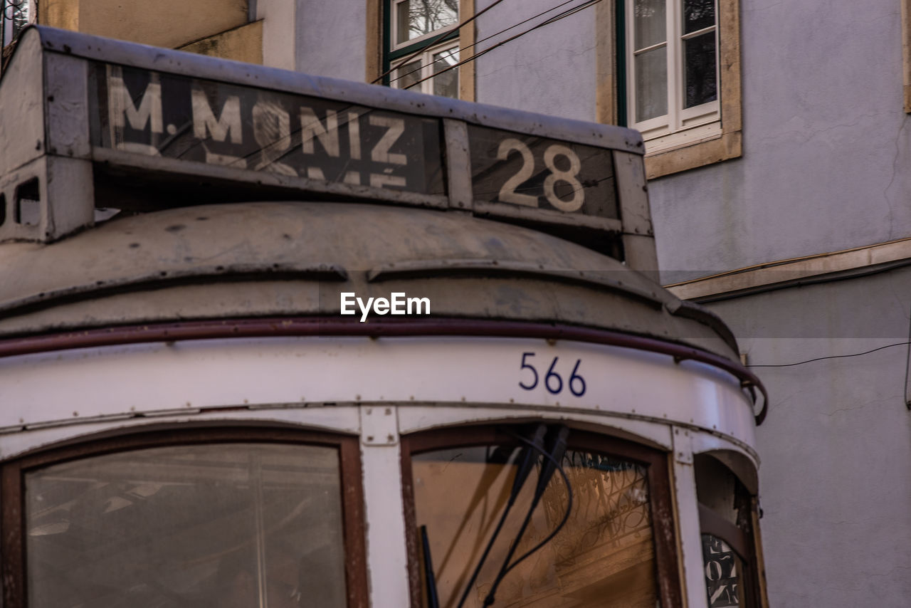 LOW ANGLE VIEW OF TEXT ON BUILDING WALL