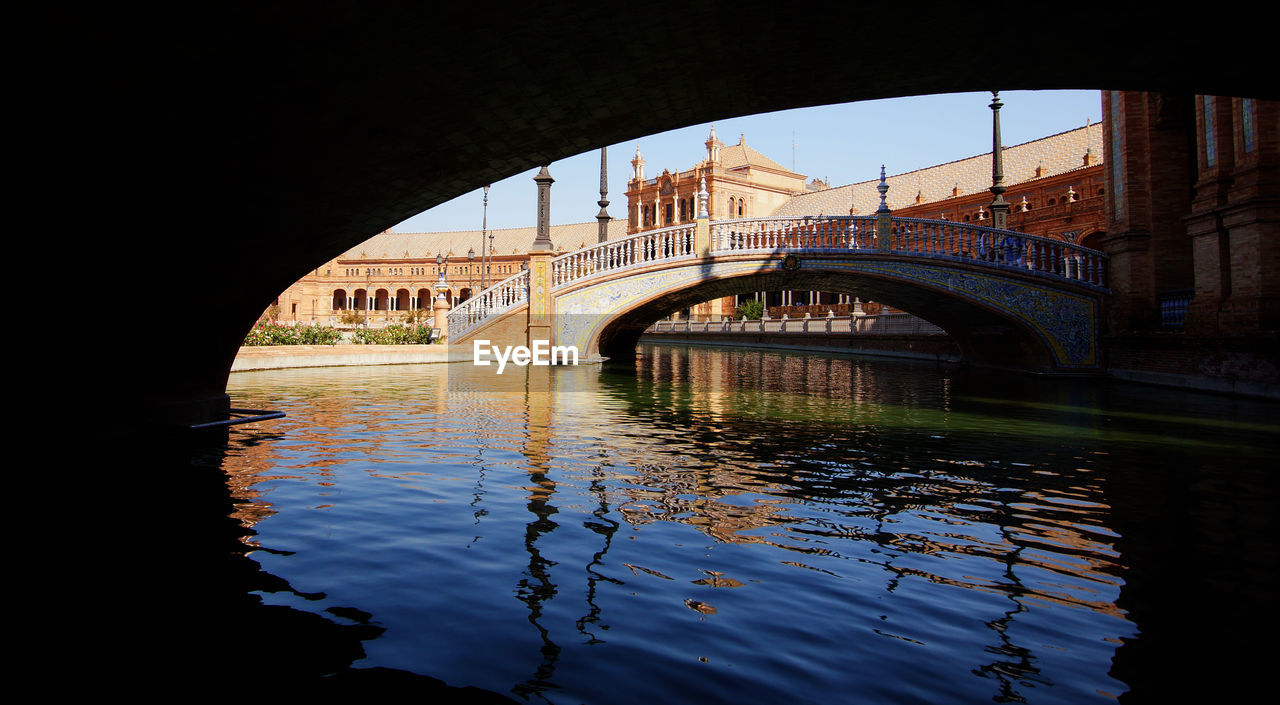 Below view of bridge over river at plaza de espana against clear sky