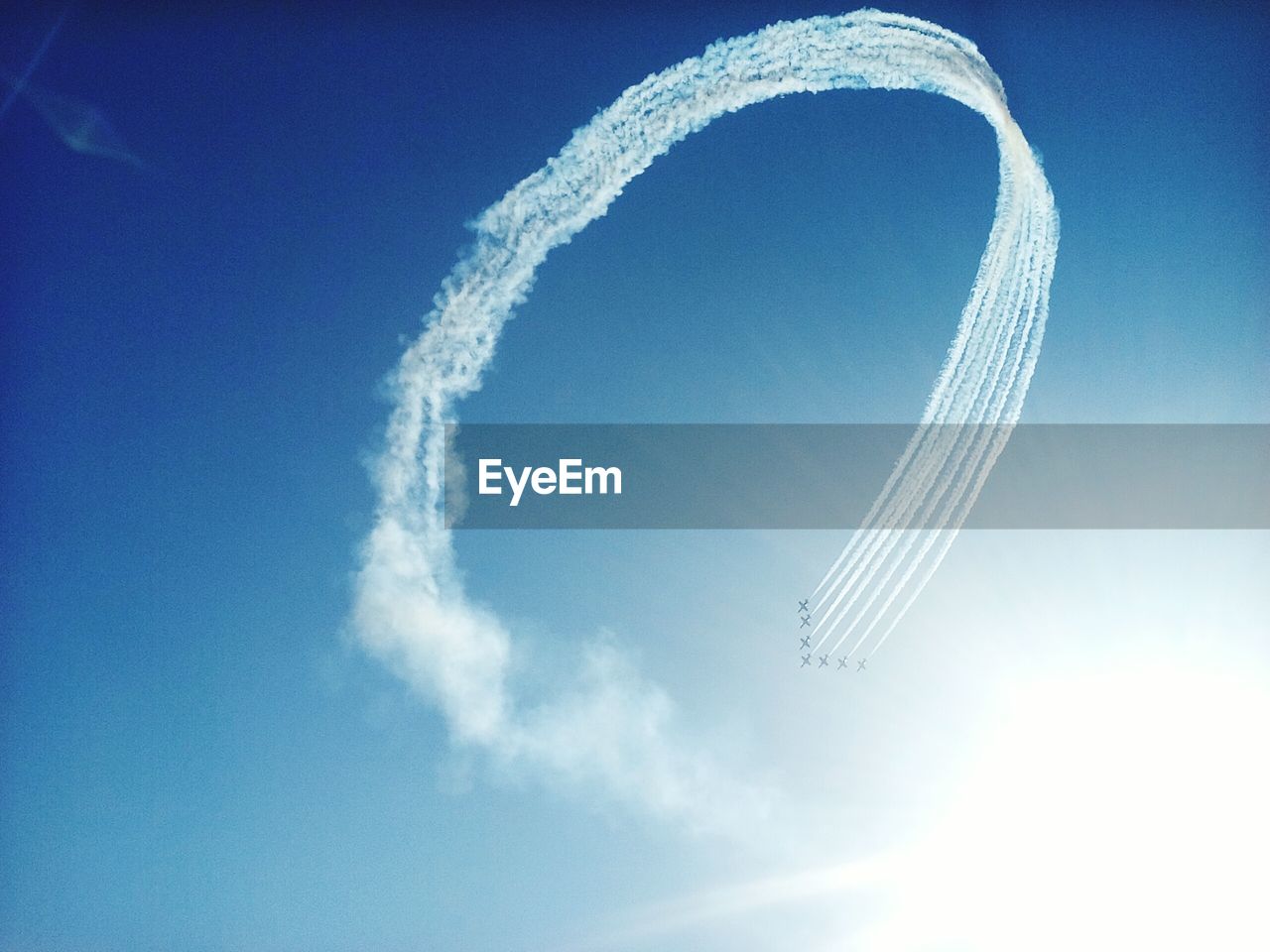 Low angle view of airplane flying against blue sky