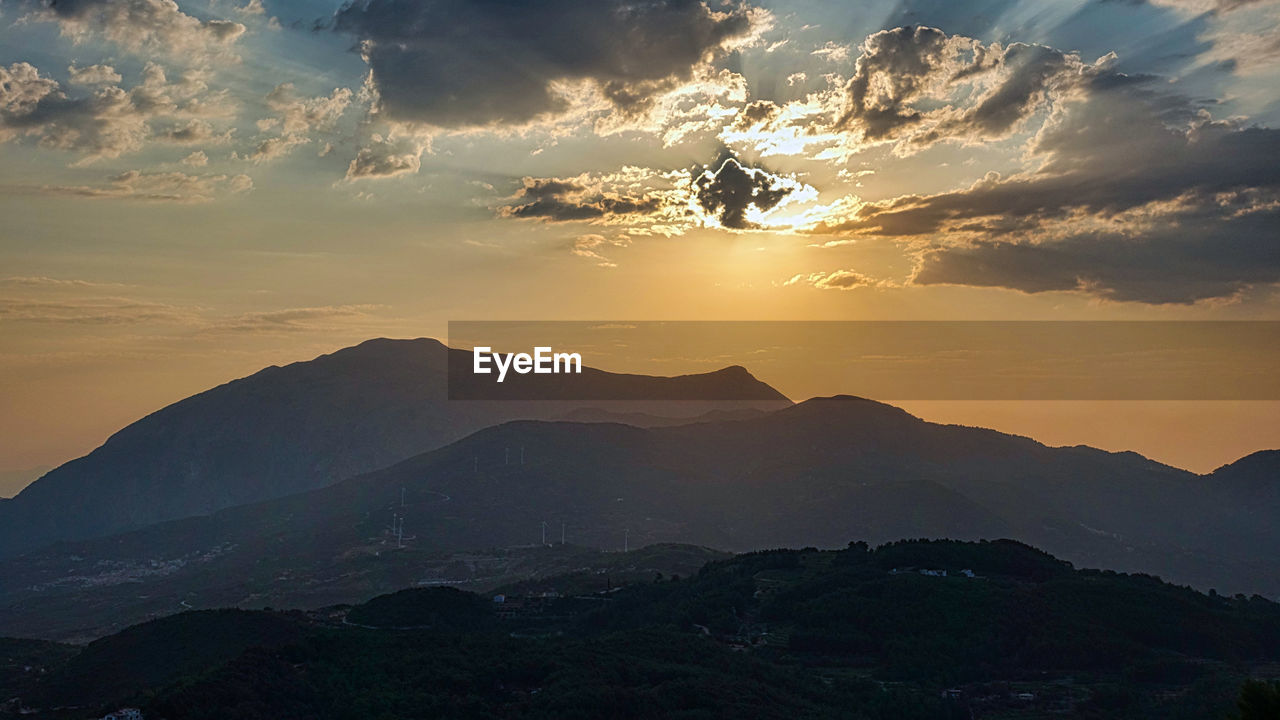 Scenic view of silhouette mountains against sky during sunset