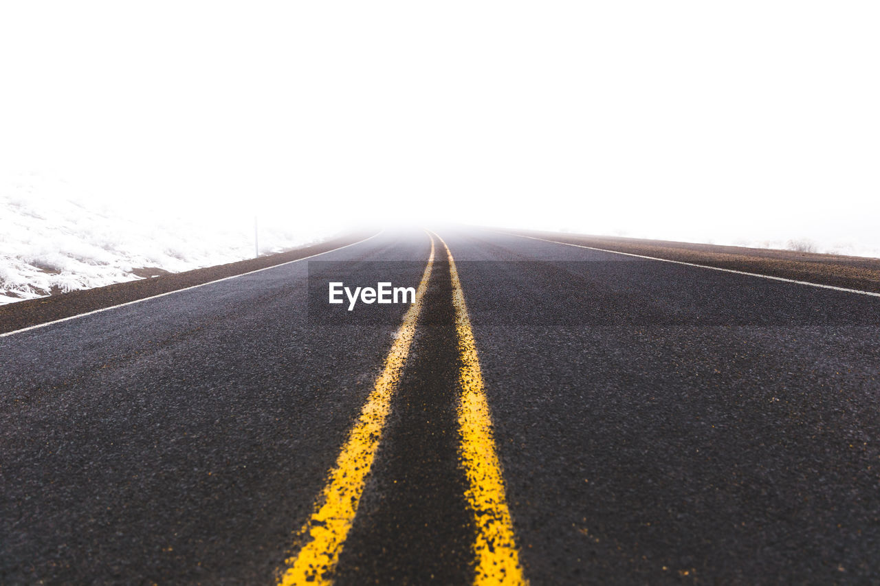 Empty road against clear sky