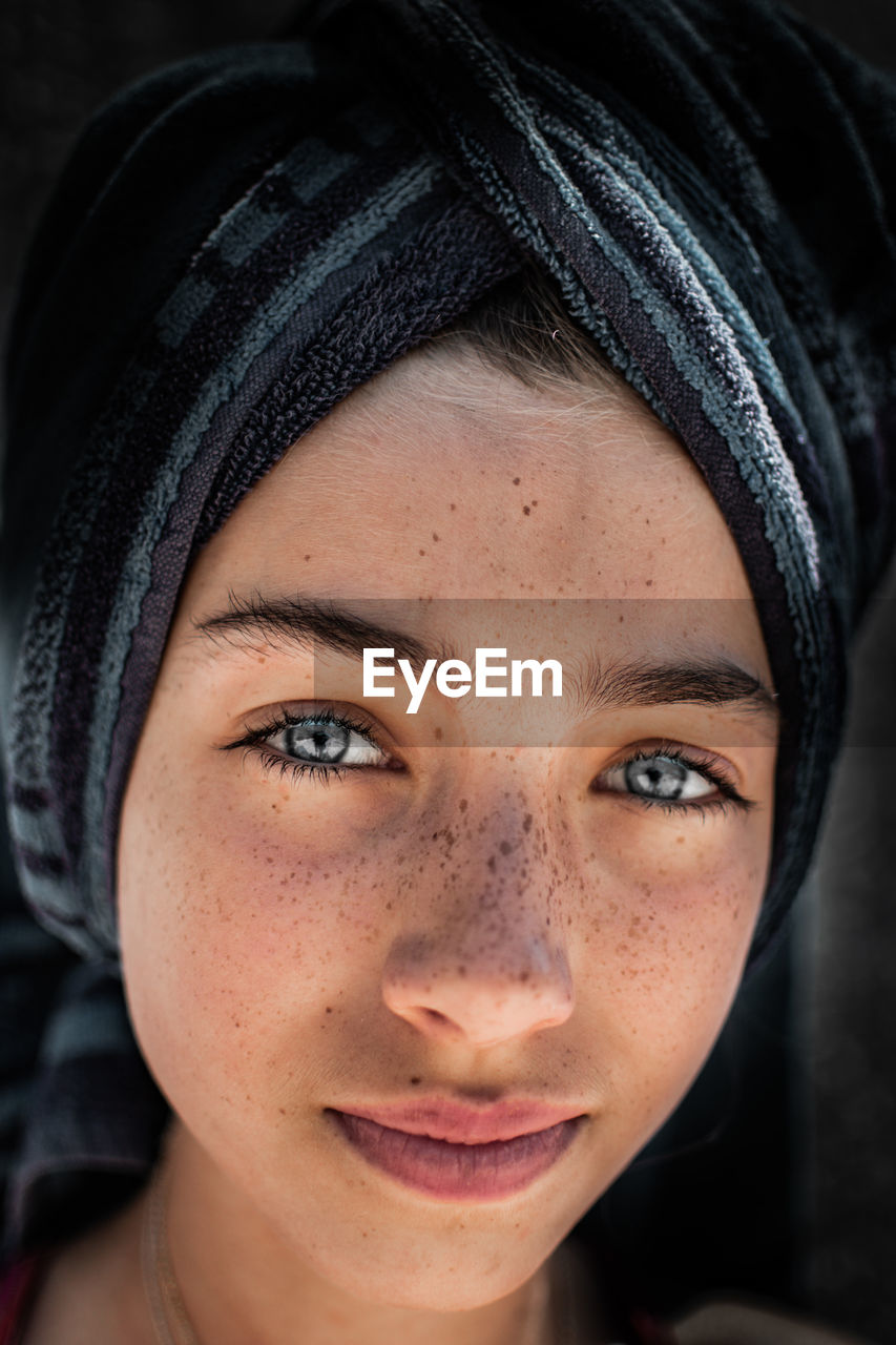 Close-up portrait of girl wearing towel on head