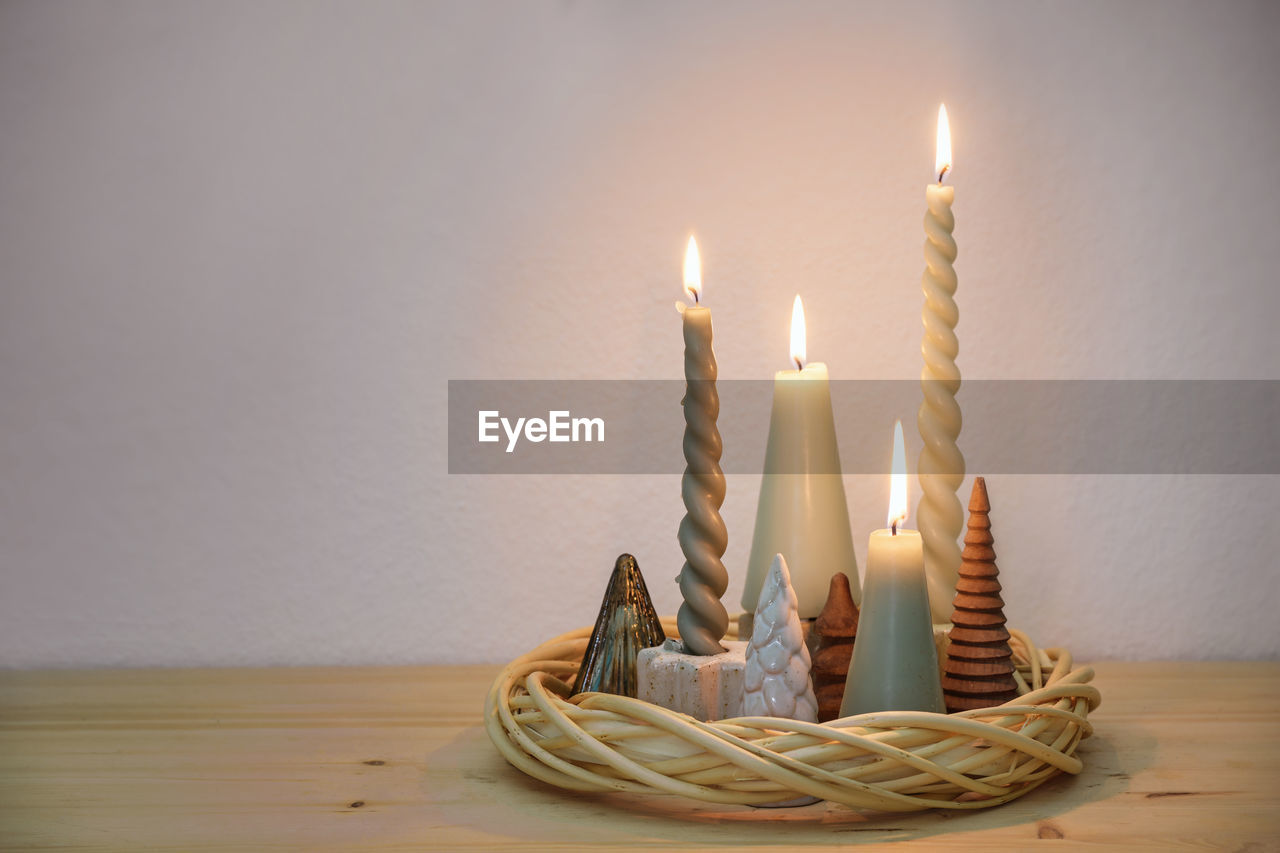 high angle view of illuminated candles on table