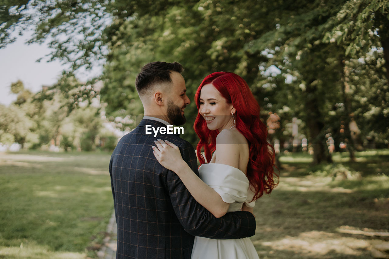 Wedding day. happy bride and groom hugging and laughing red hair diversity