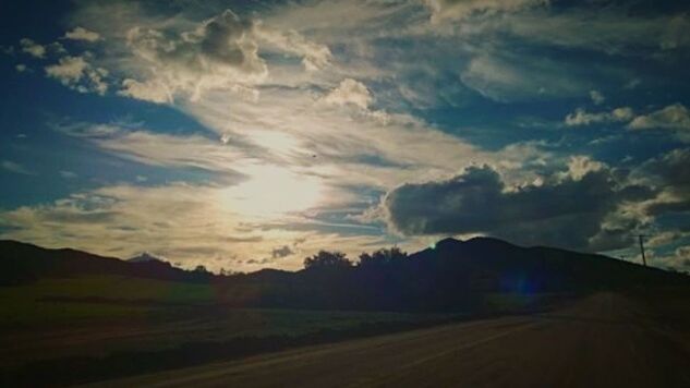 SCENIC VIEW OF MOUNTAINS AGAINST CLOUDY SKY