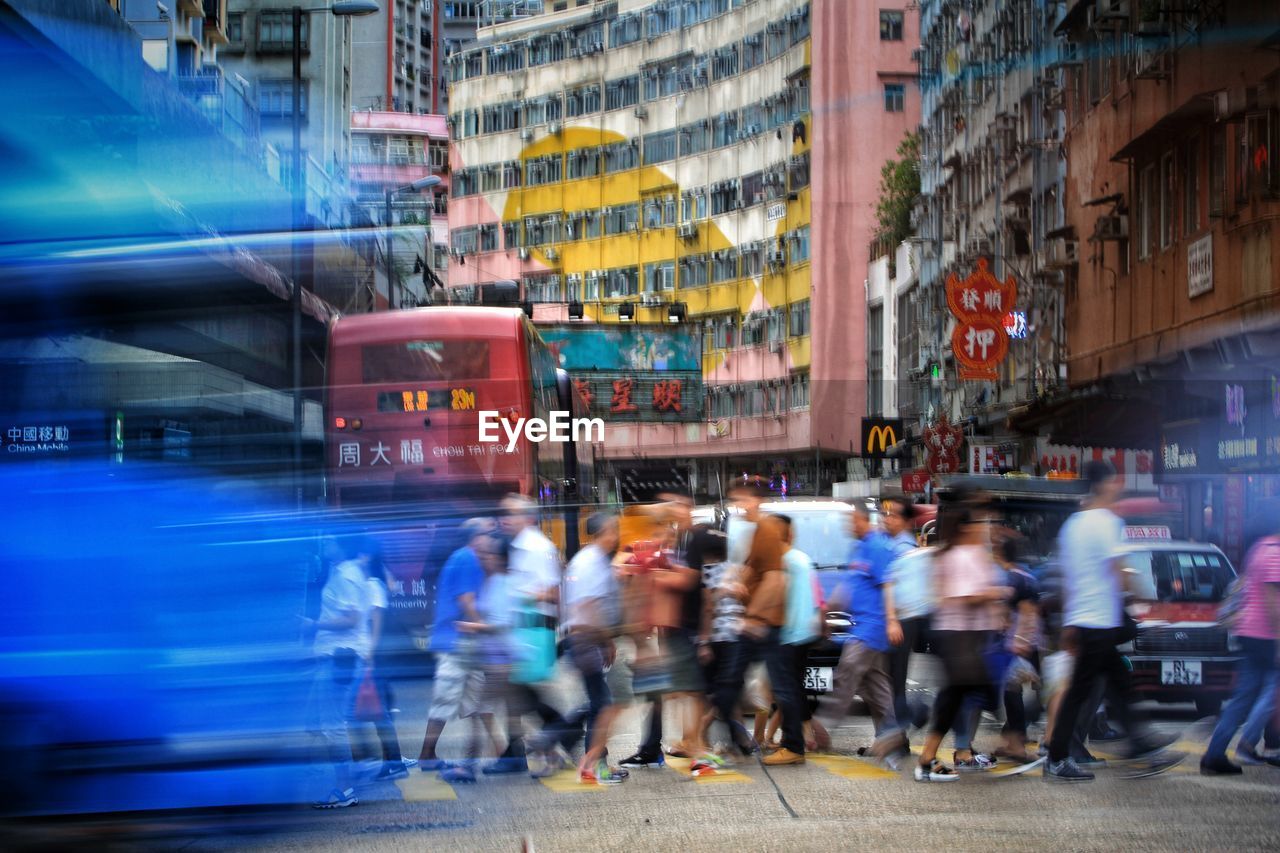 CROWD WALKING ON CITY STREET