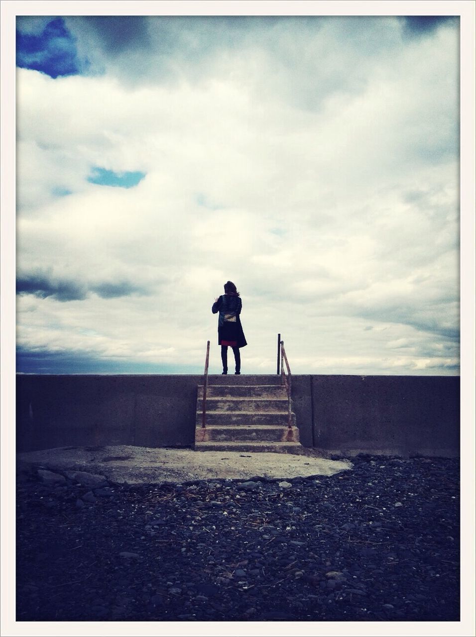 SILHOUETTE OF WOMAN STANDING AGAINST CLOUDY SKY