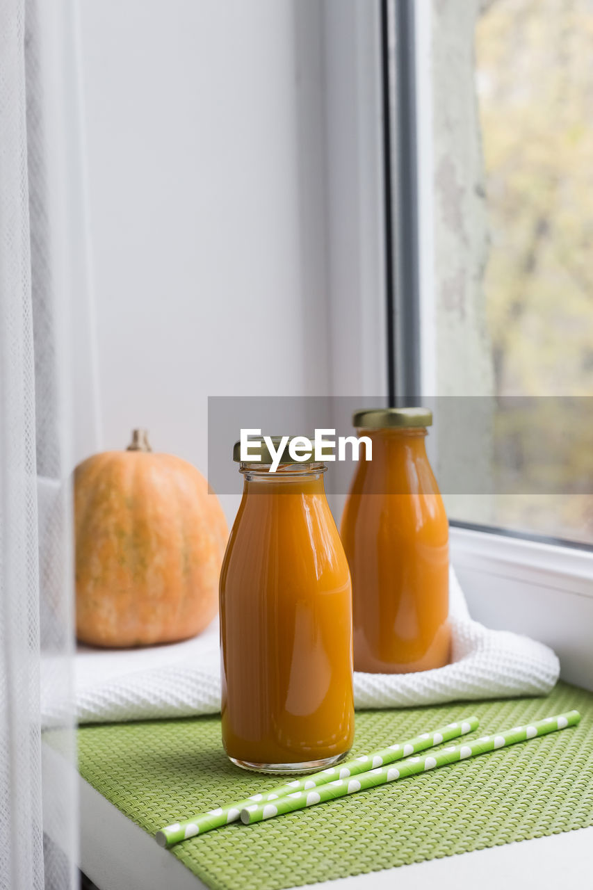 CLOSE-UP OF ORANGE AND COFFEE ON TABLE
