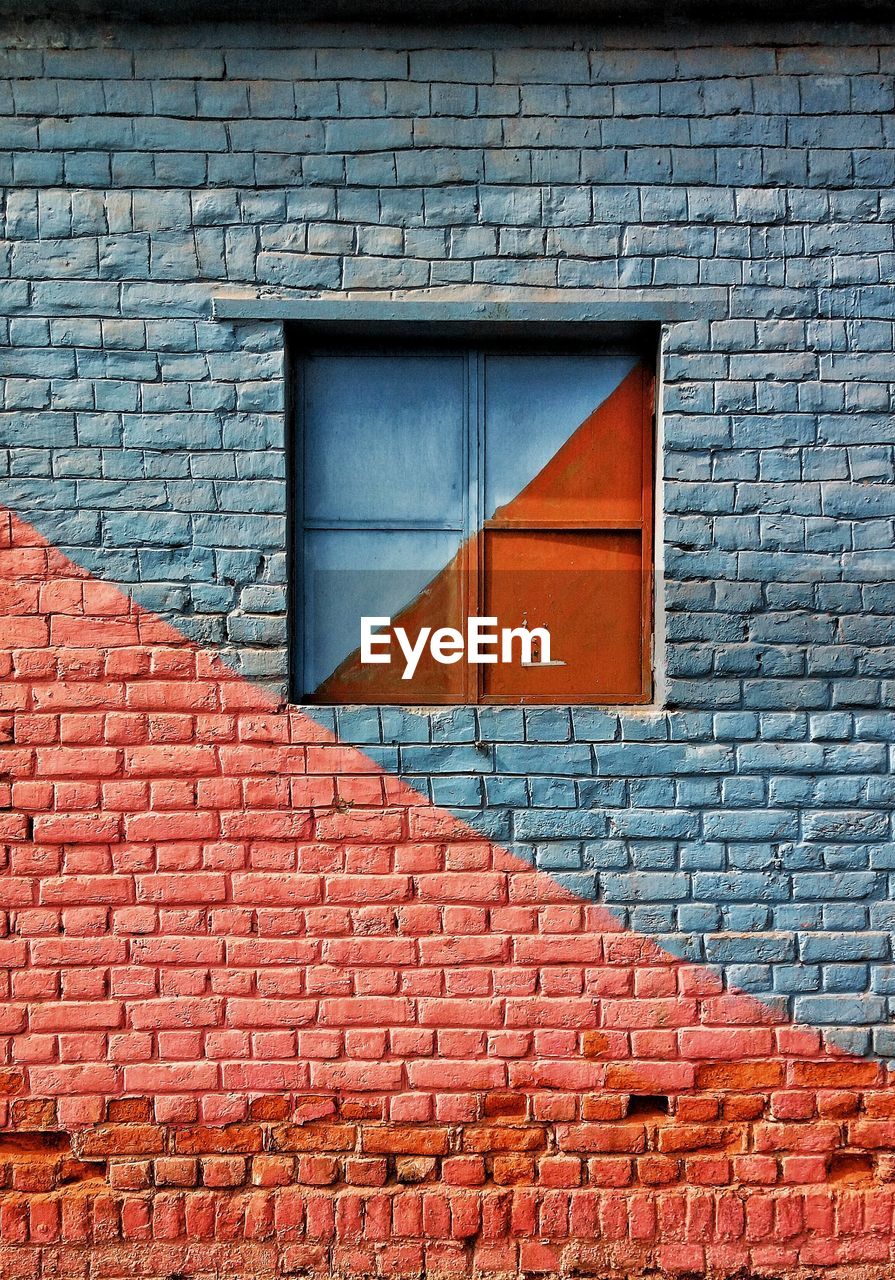 CLOSE-UP OF BRICK WALL WITH WINDOW