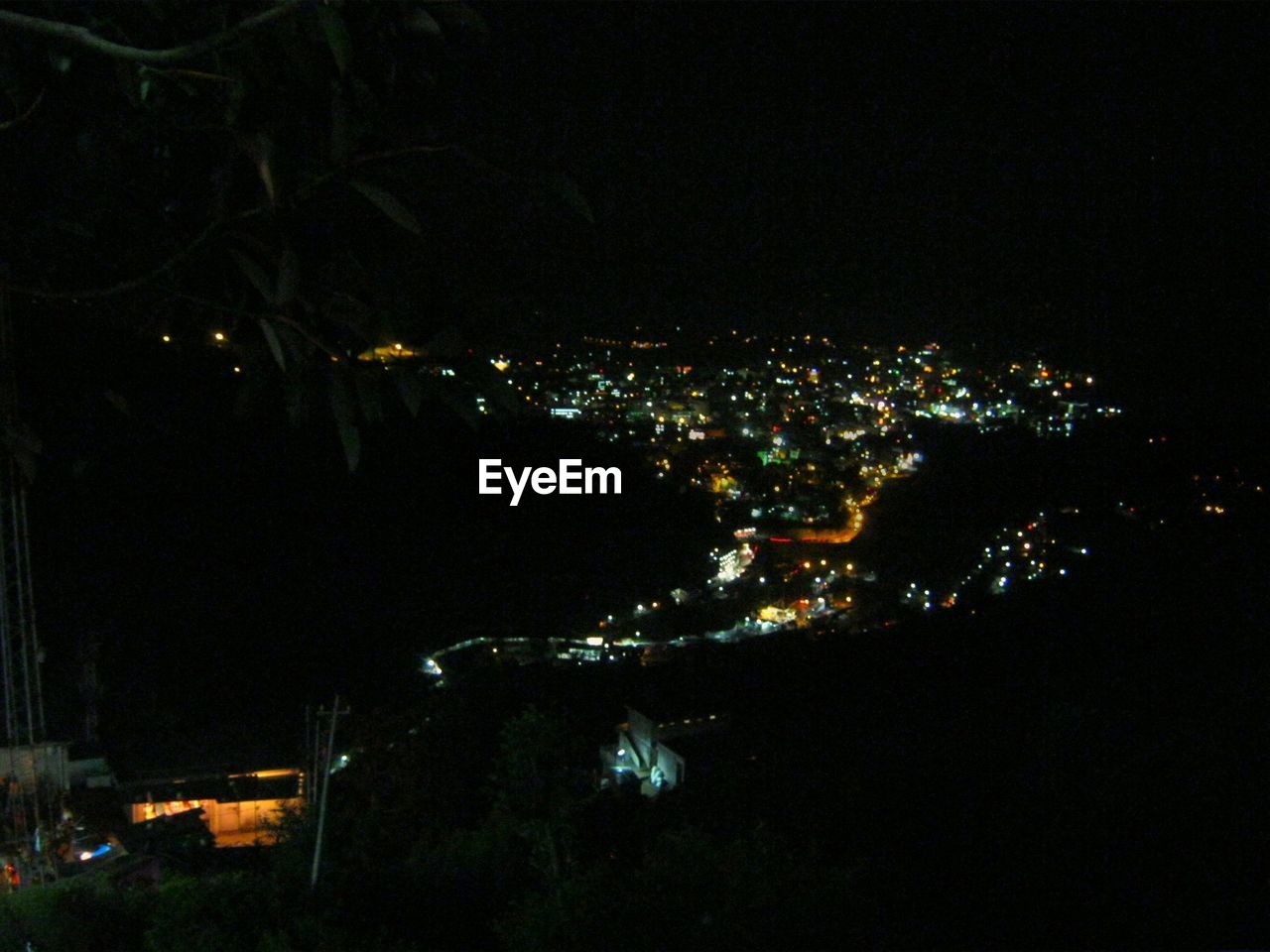 HIGH ANGLE VIEW OF ILLUMINATED CITY BUILDINGS AT NIGHT