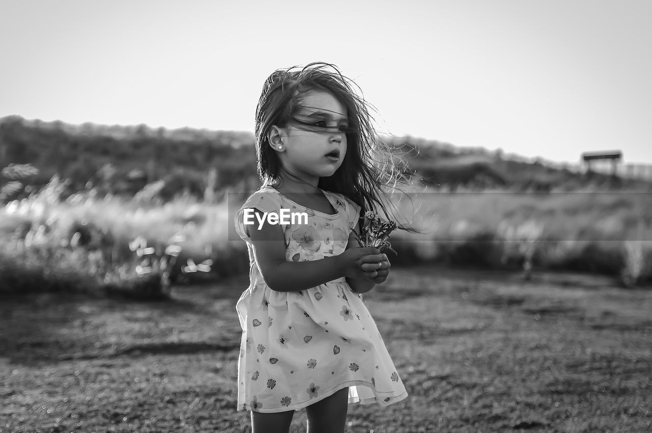 Portrait of child standing on field