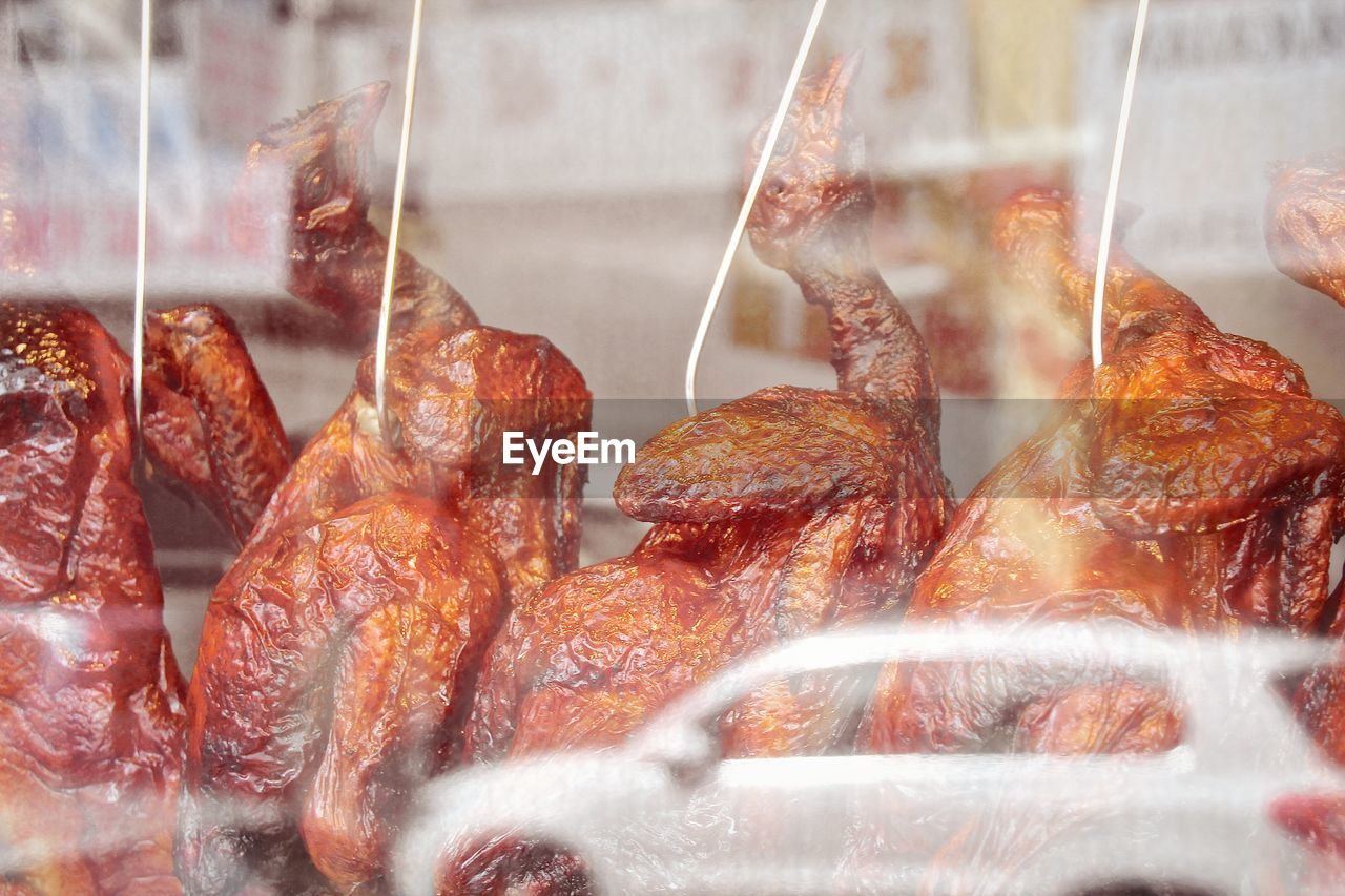 Close-up of roasted duck meat at window display