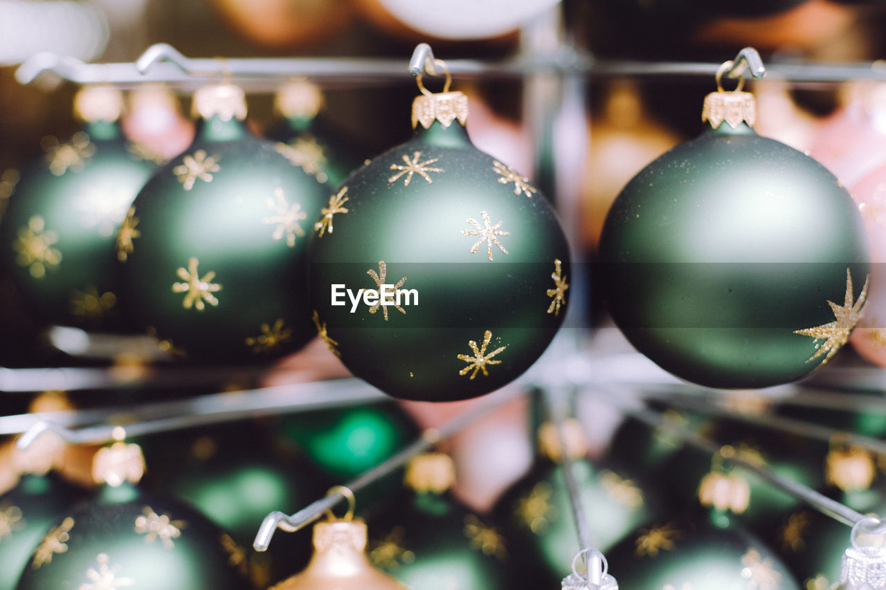 Close-up of christmas decorations hanging indoors