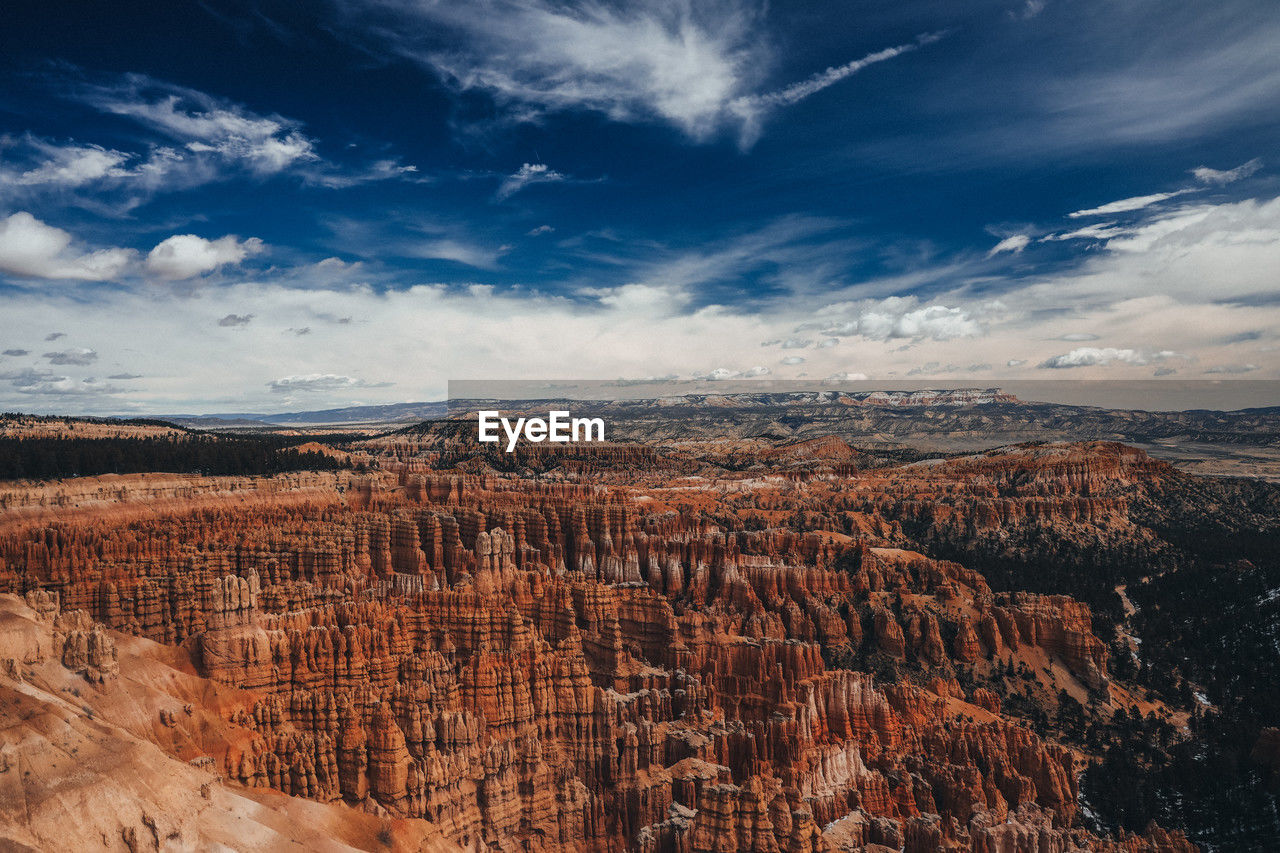environment, landscape, sky, scenics - nature, cloud, beauty in nature, nature, travel destinations, travel, mountain, rock, land, non-urban scene, no people, canyon, tranquility, tourism, rock formation, tranquil scene, outdoors, mountain range, desert, blue, remote, day, extreme terrain, geology, sunlight, idyllic, horizon over land, horizon