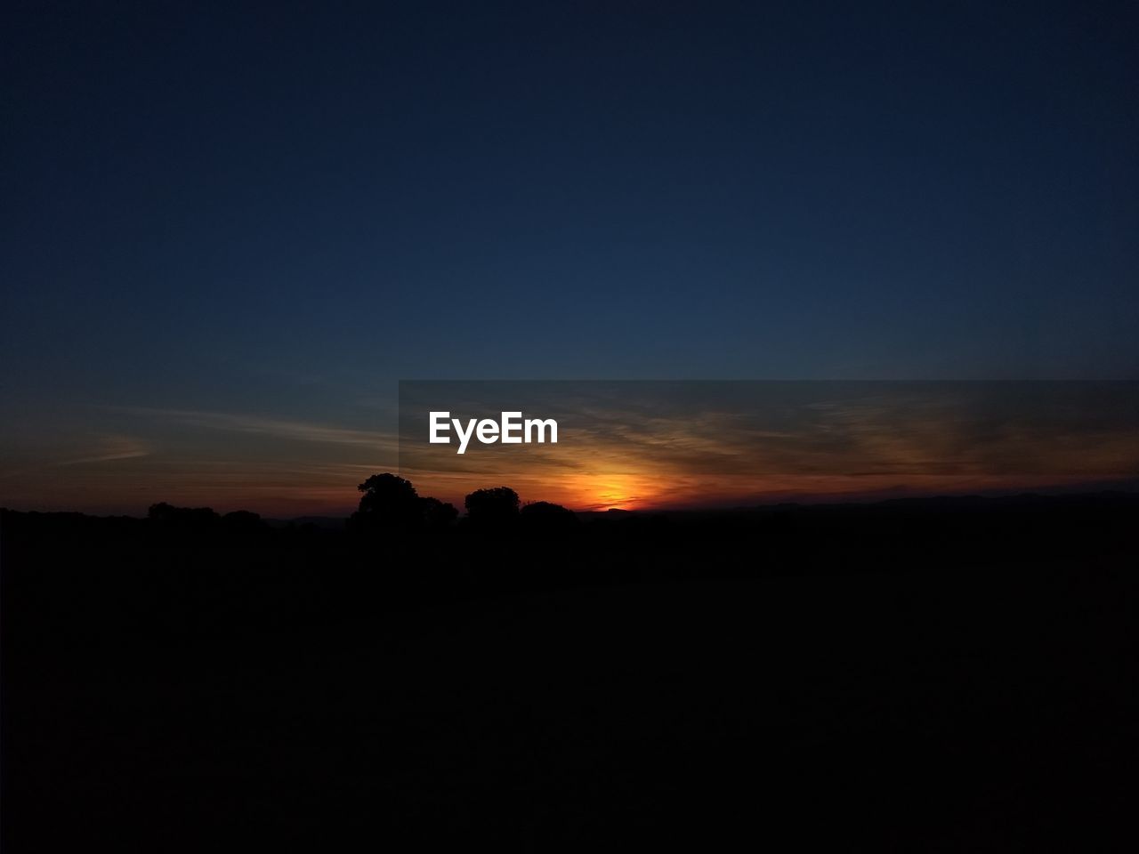 SILHOUETTE LANDSCAPE AGAINST SKY AT SUNSET