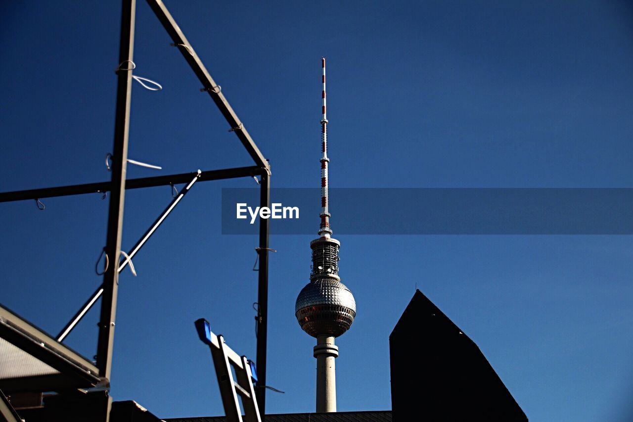 Low angle view of fernsehturm against blue sky