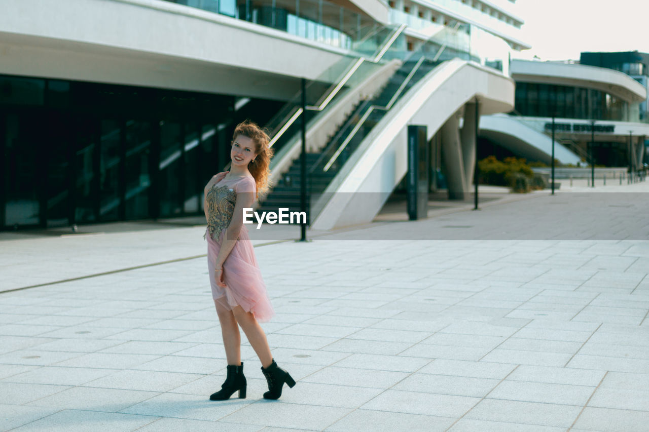 WOMAN STANDING ON FOOTPATH