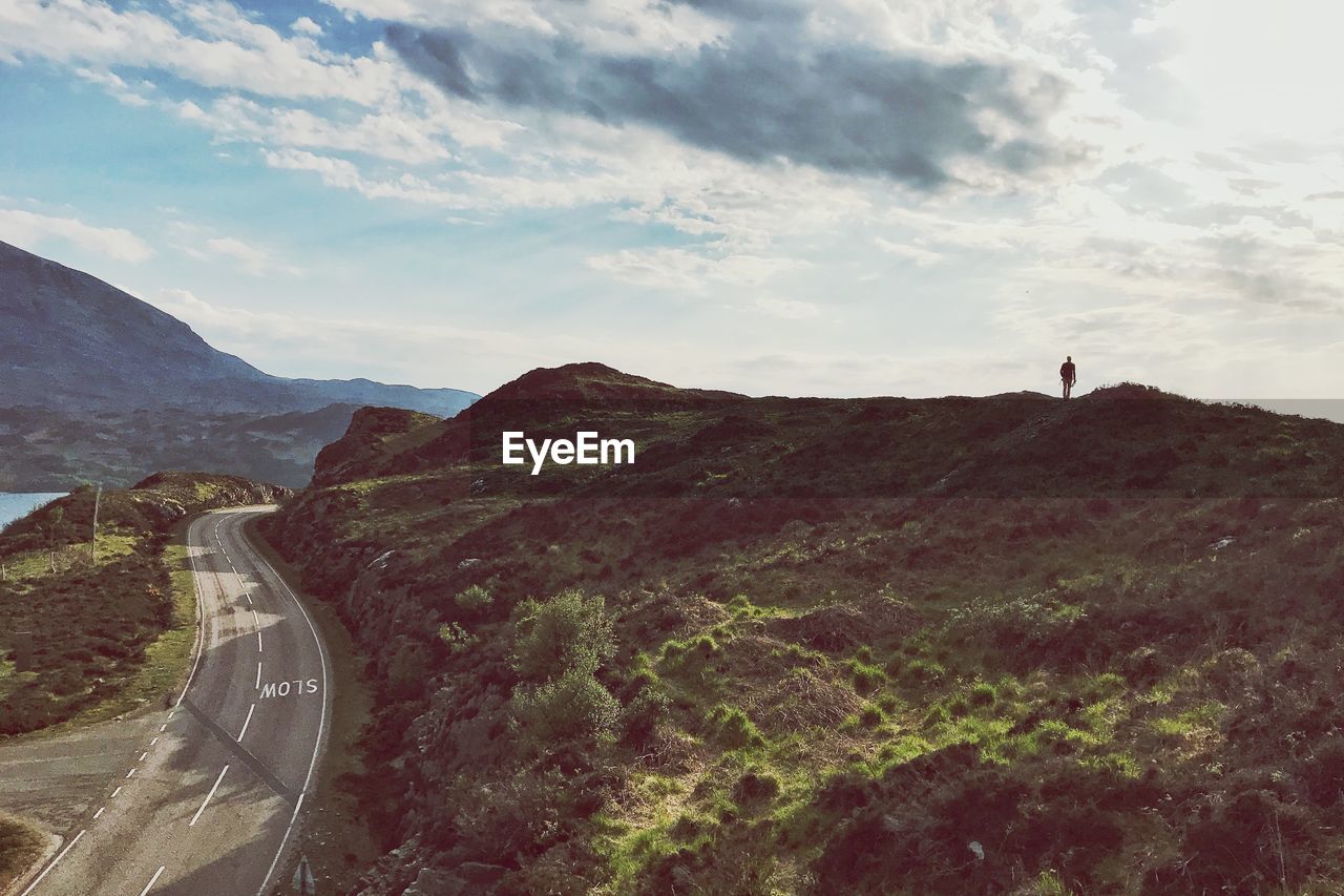 ROAD BY MOUNTAIN AGAINST SKY