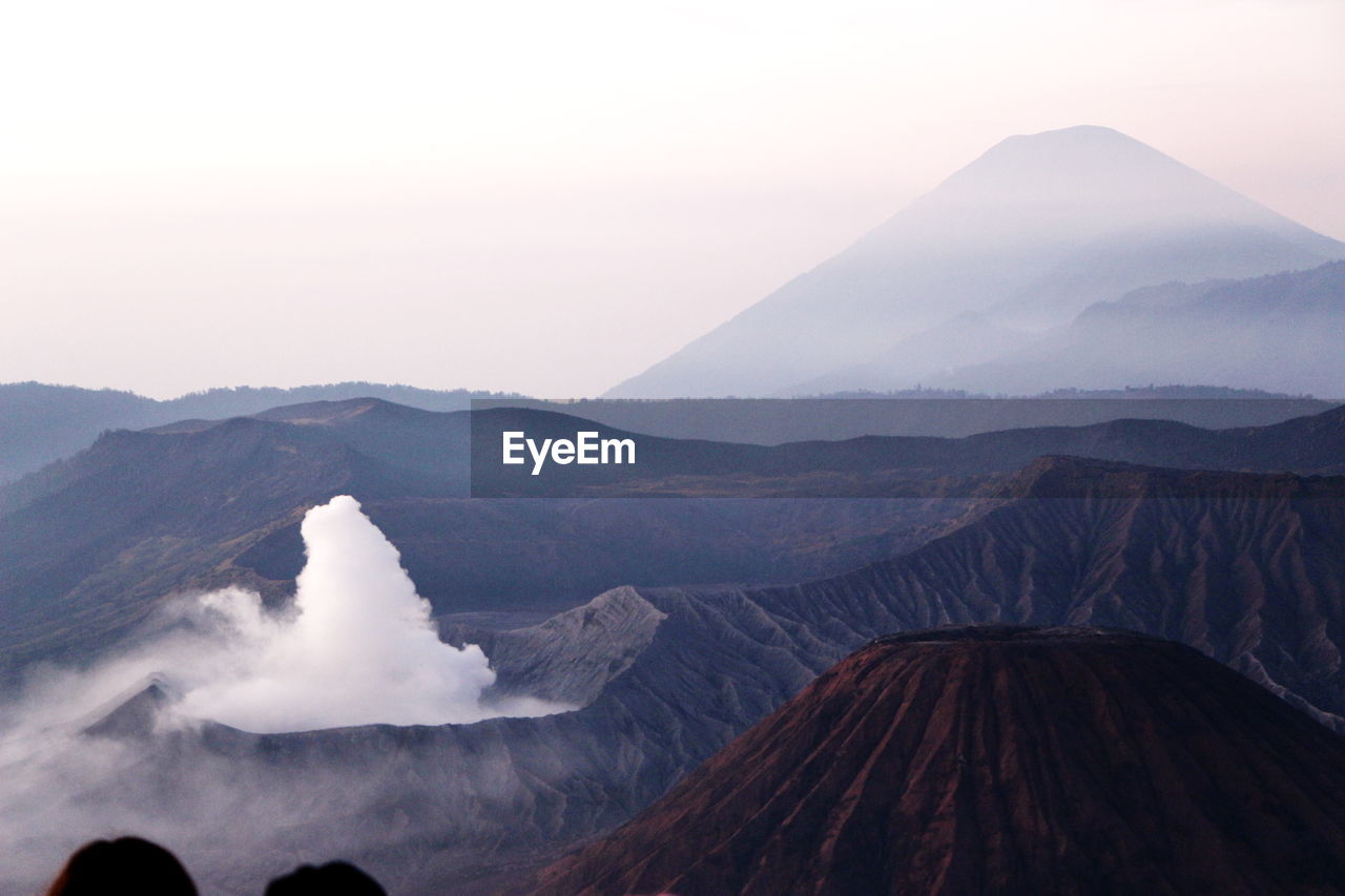 Scenic view of volcanic landscape against sky during sunset