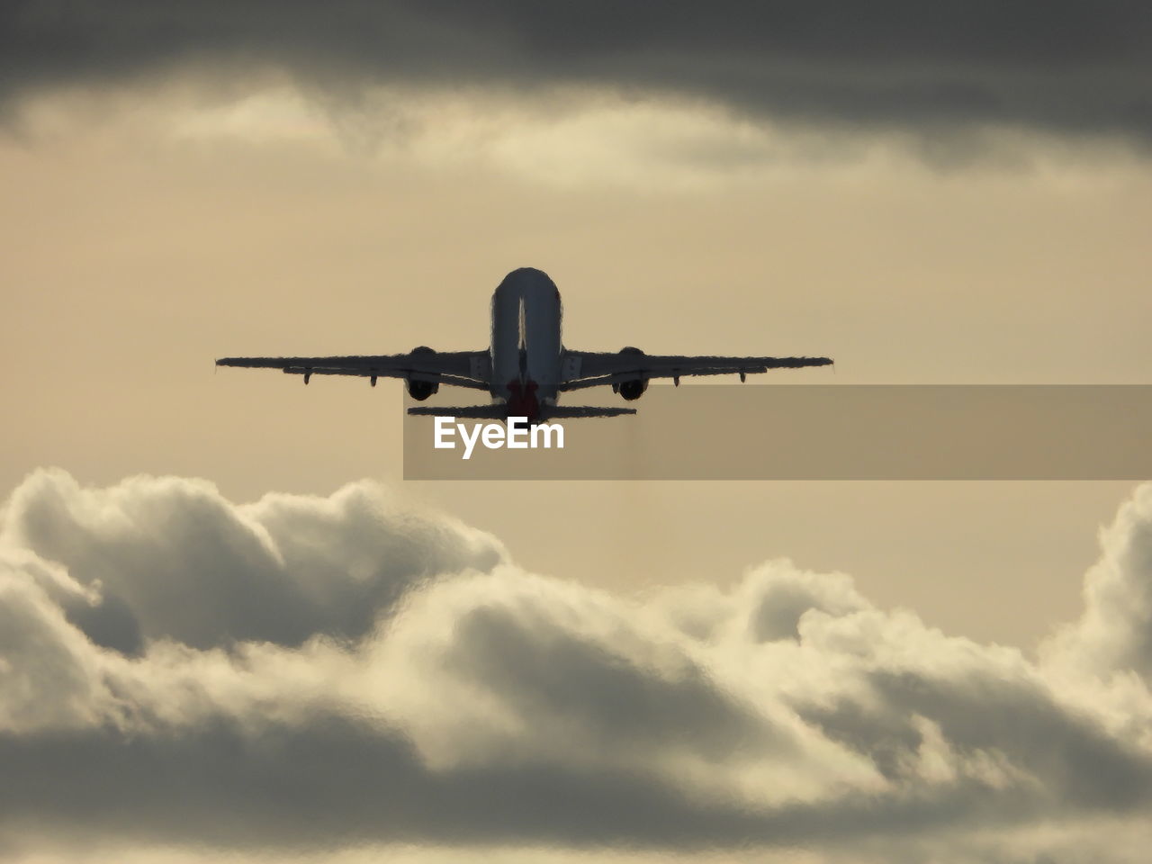 Low angle view of airplane flying against sky