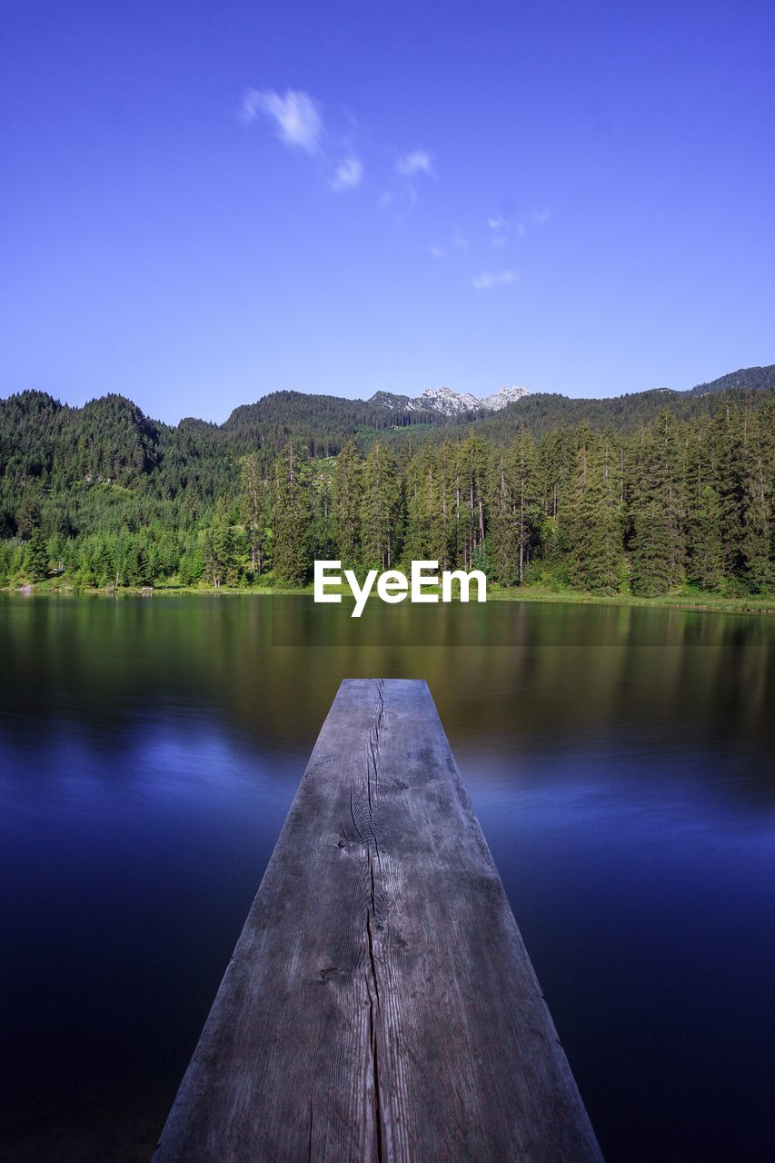 Scenic view of lake against blue sky