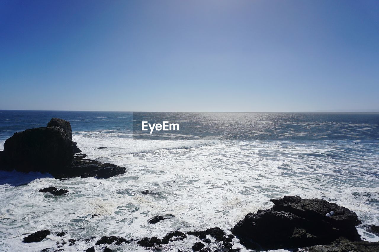 Scenic view of sea against clear blue sky