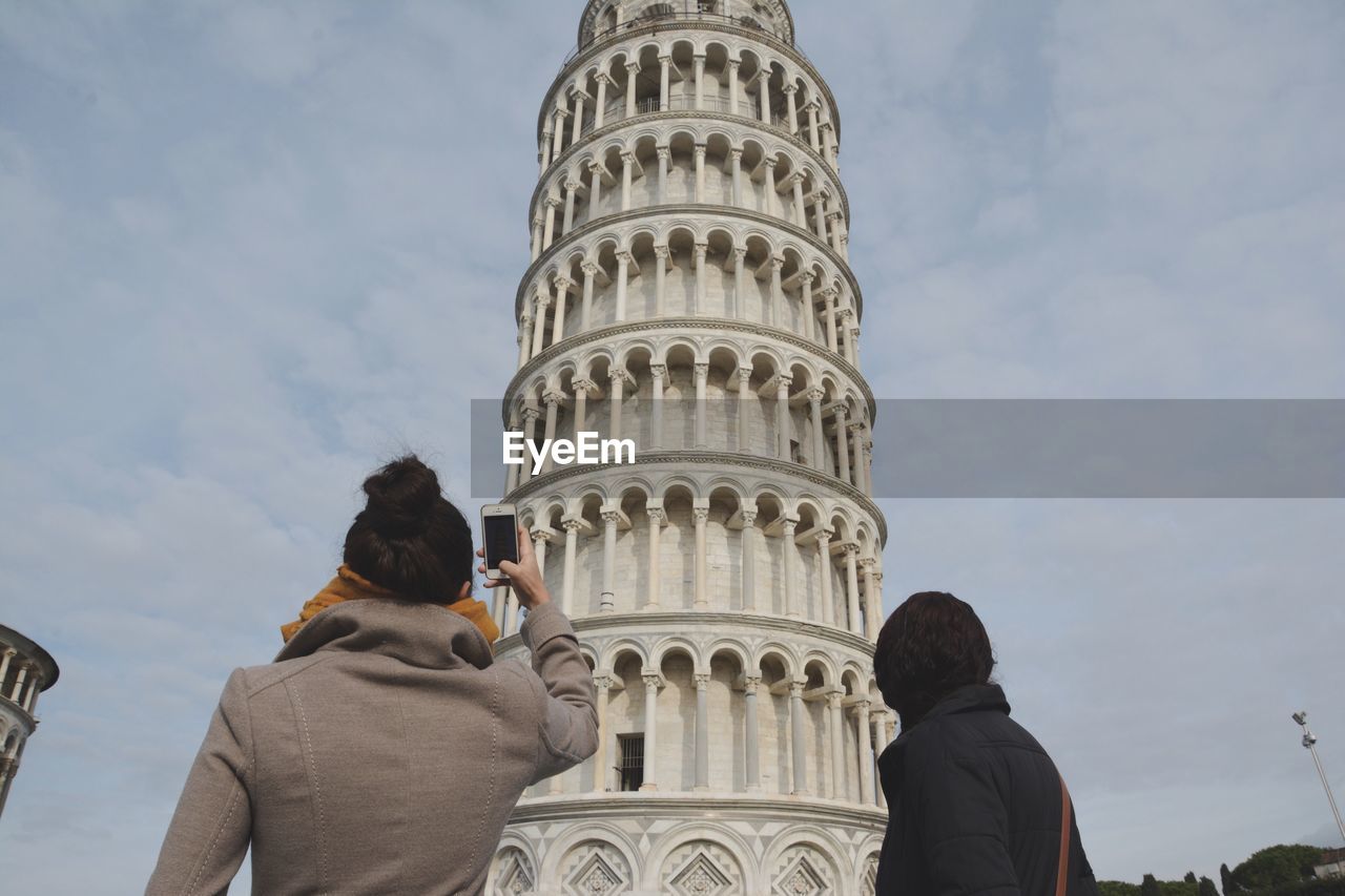 Rear view of women against leaning tower of pisa