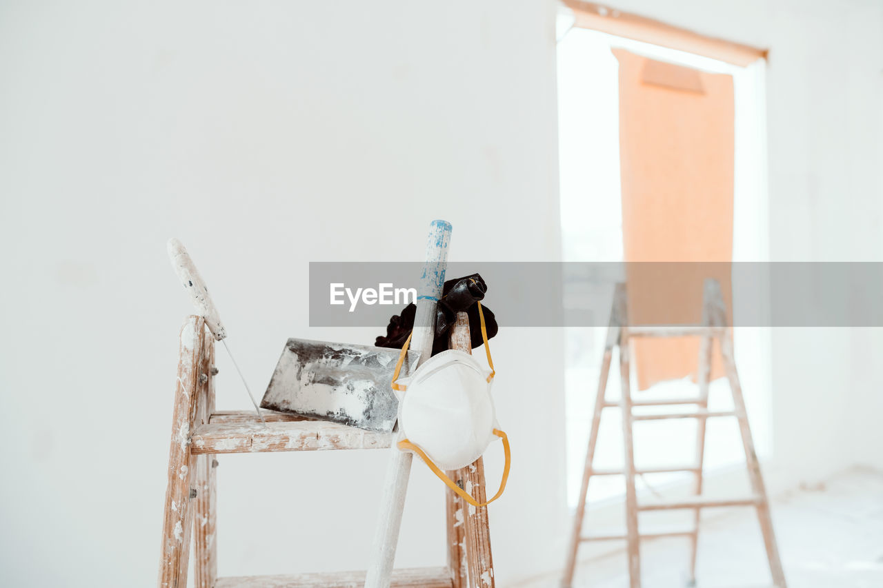 Ladders and tools on white room at construction site. painting walls. home improvement, renovation