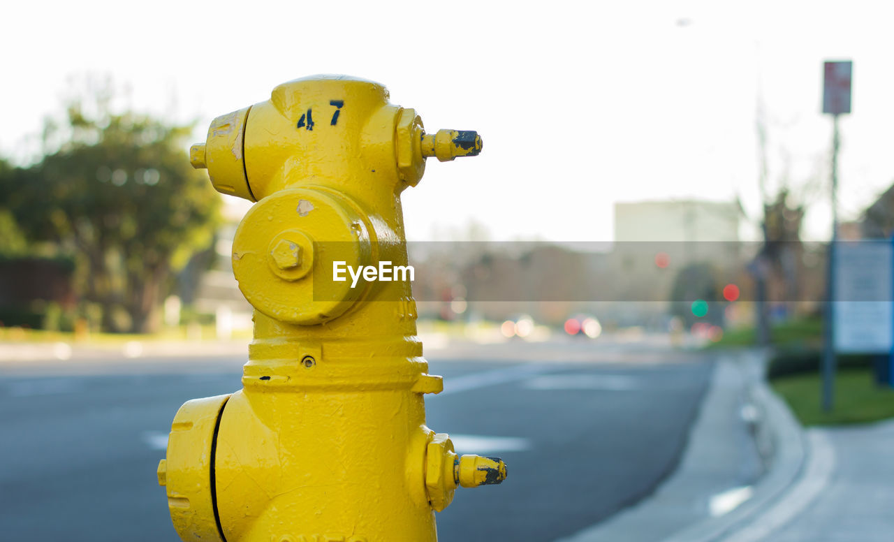 Close-up of yellow fire hydrant against sky