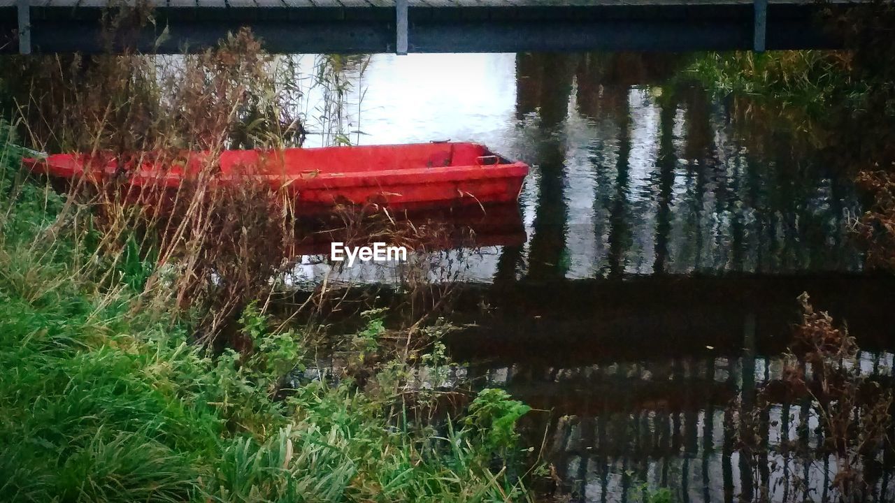 RED BOAT ON LAKE