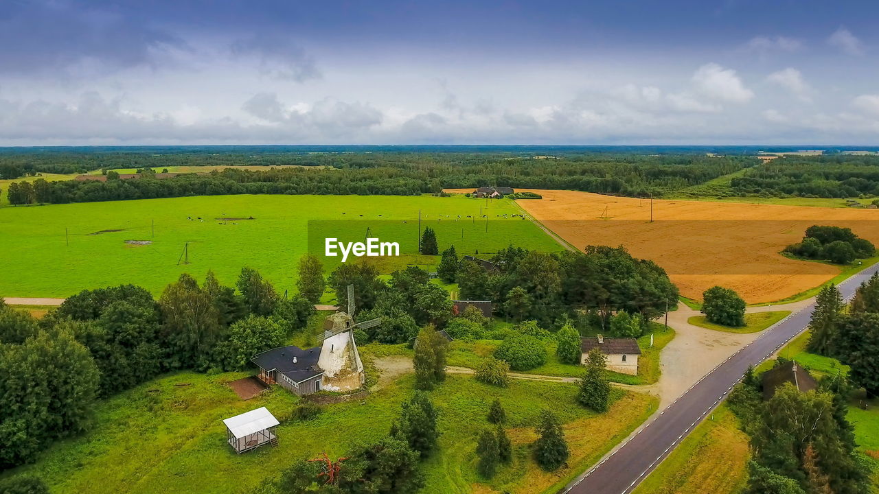 SCENIC VIEW OF FARMS AGAINST SKY