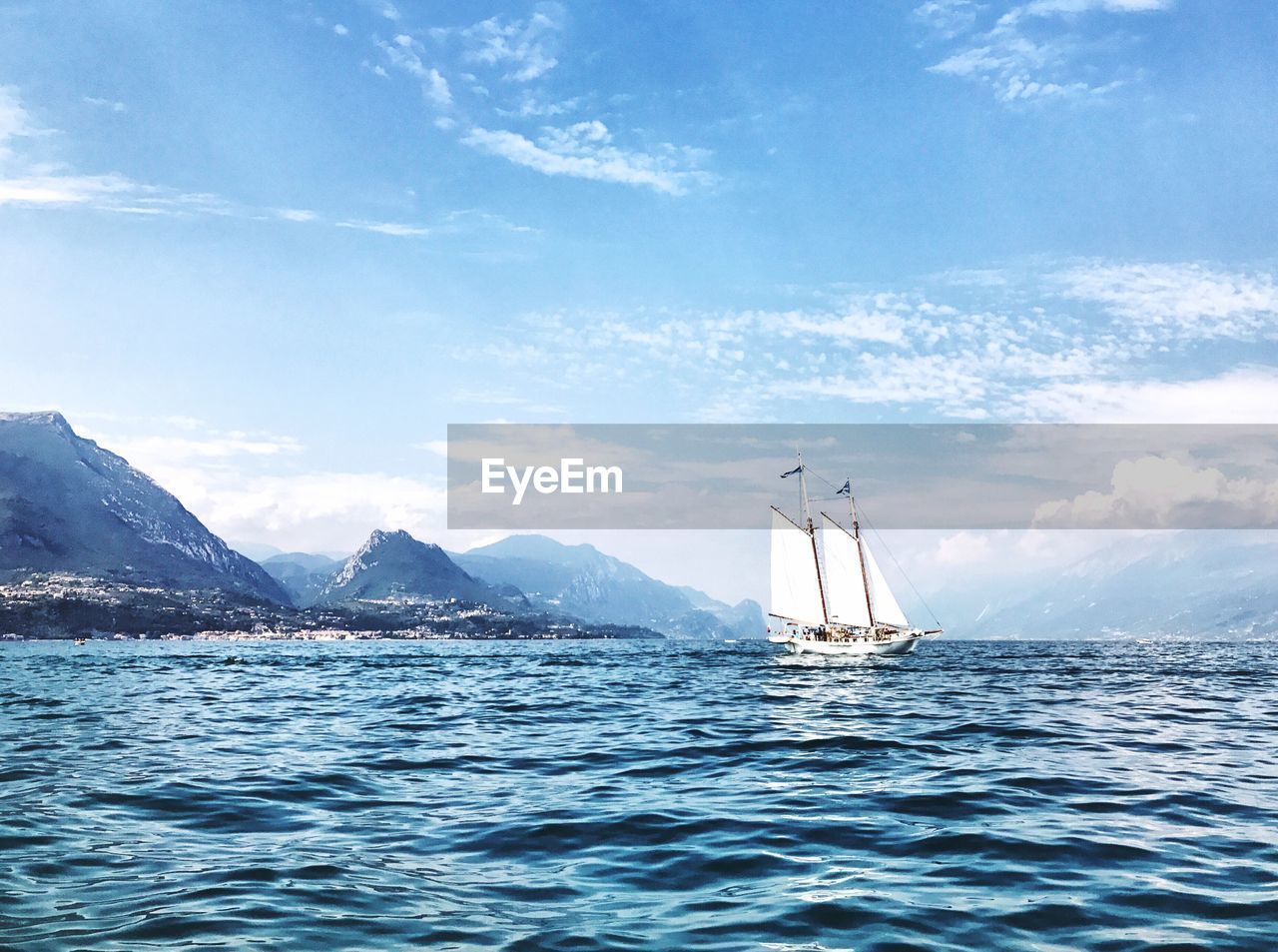 Sailboat sailing on sea against sky