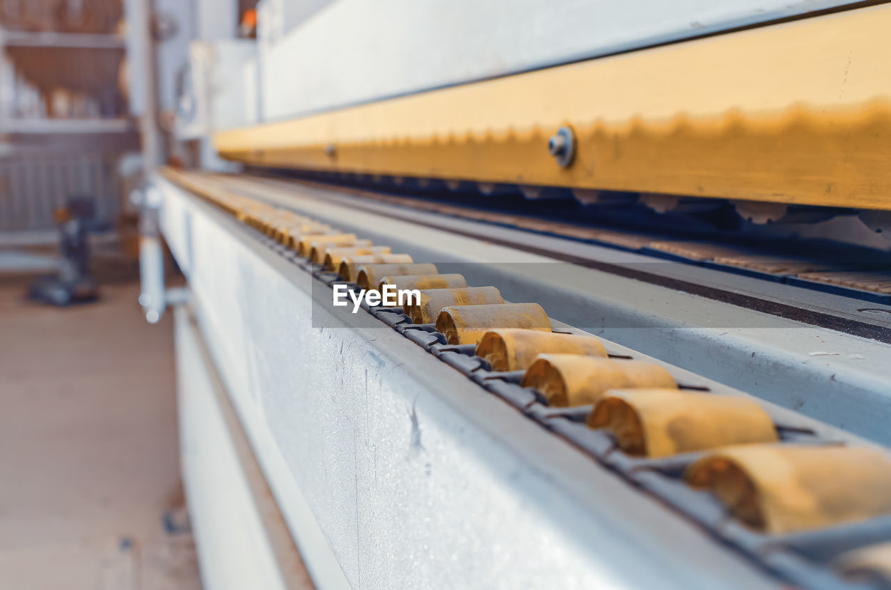 Close-up of a part of a wooden part on an edge-banding machine