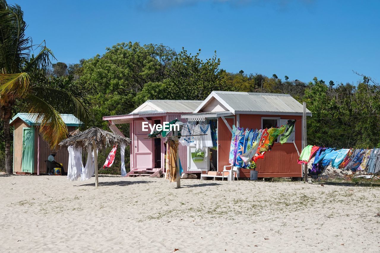 built structures on beach against blue sky