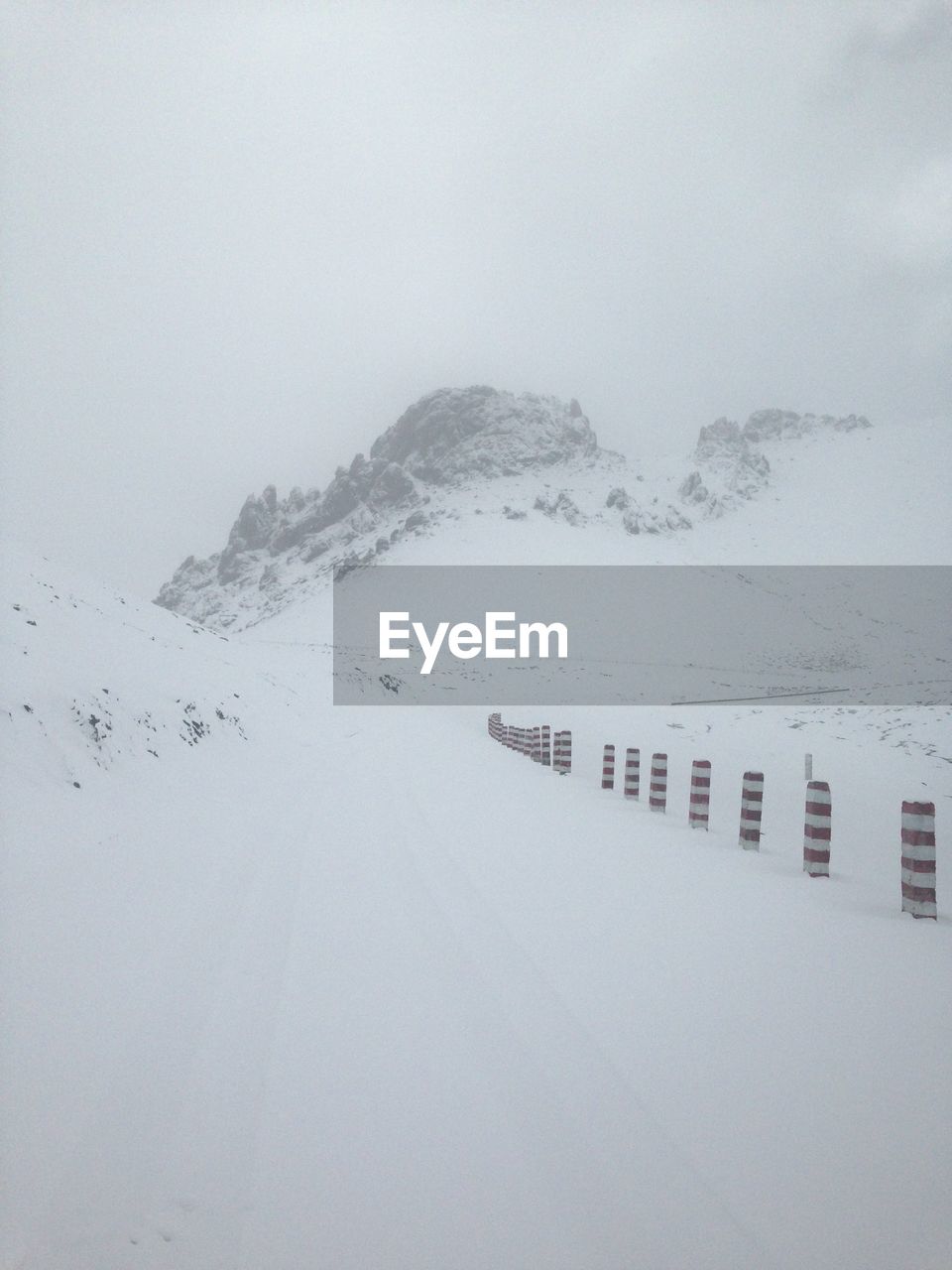 SNOW COVERED MOUNTAINS AGAINST SKY