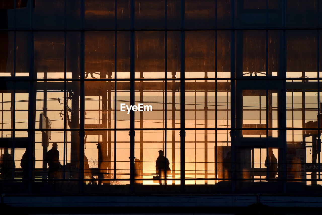 Rear view of silhouette man walking in modern building