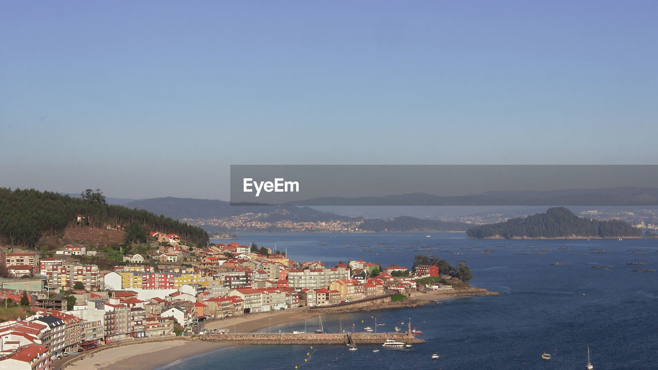 SCENIC VIEW OF SEA BY BUILDINGS AGAINST SKY