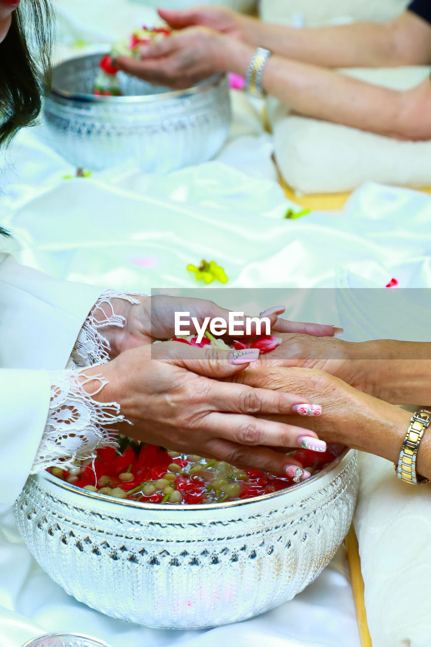 Cropped image of woman washing hands during traditional ceremony