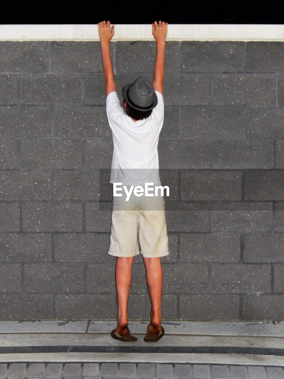 Low section of young man standing on ground 