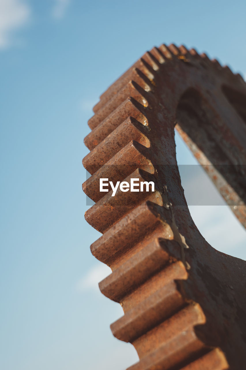 Low angle close-up of metal against sky