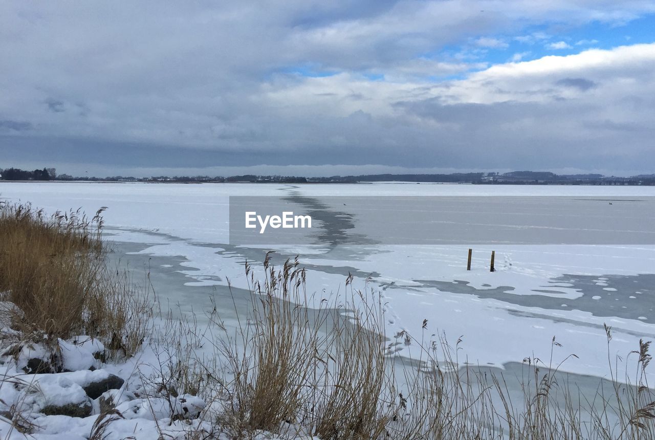 Scenic view of sea against cloudy sky