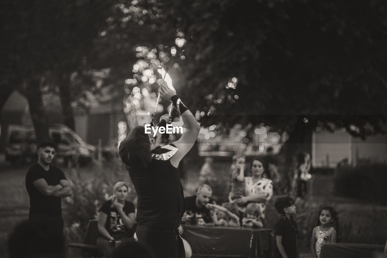 GROUP OF PEOPLE ENJOYING AT MUSIC CONCERT