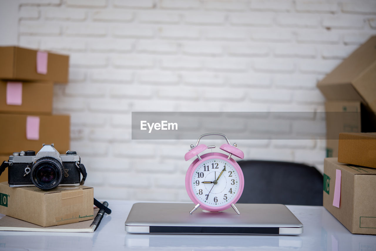 CLOSE-UP OF CLOCK ON TABLE