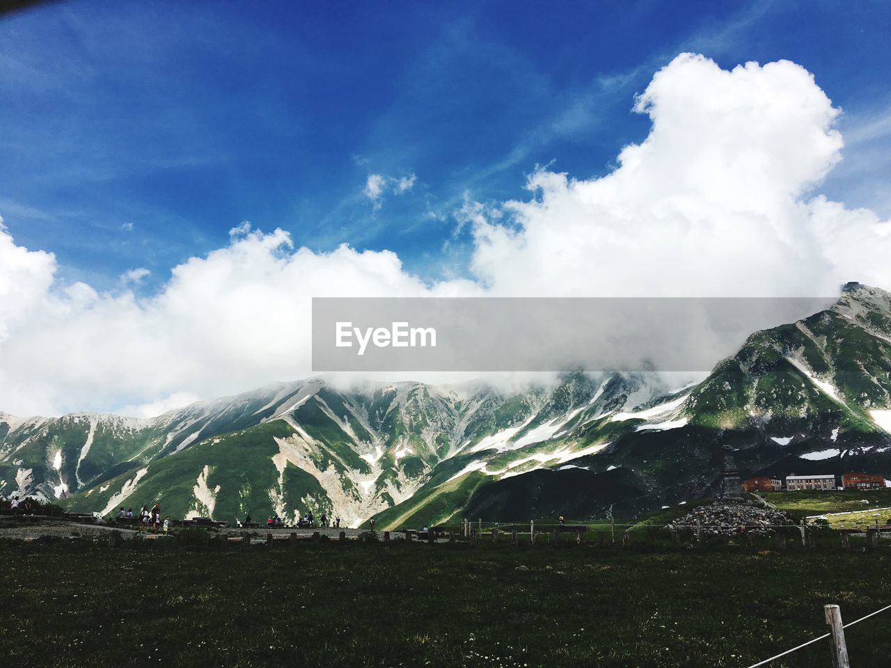 View of snowcapped mountain against cloudy sky