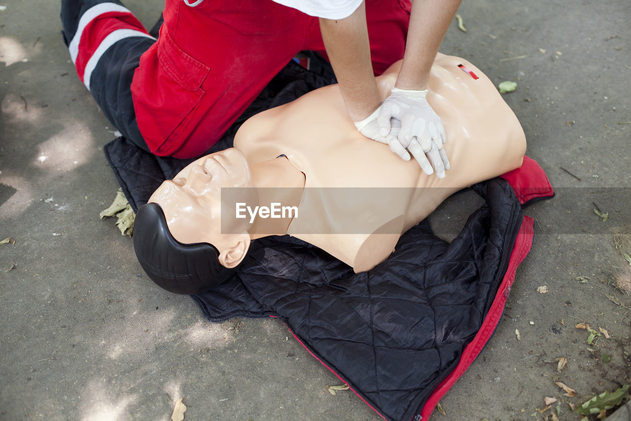 Low section of woman applying cpr on dummy